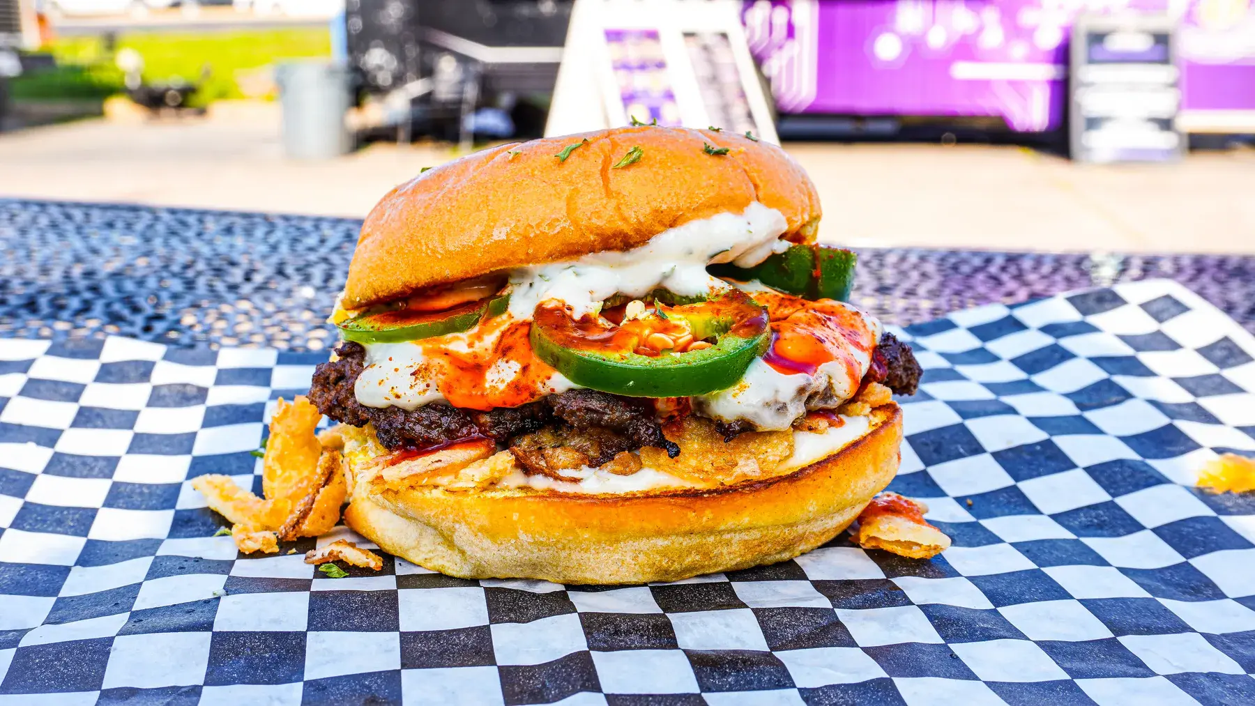 Bunqua Burger with cheese, jalapenos, fried onions, and FOMO sauce in Houston