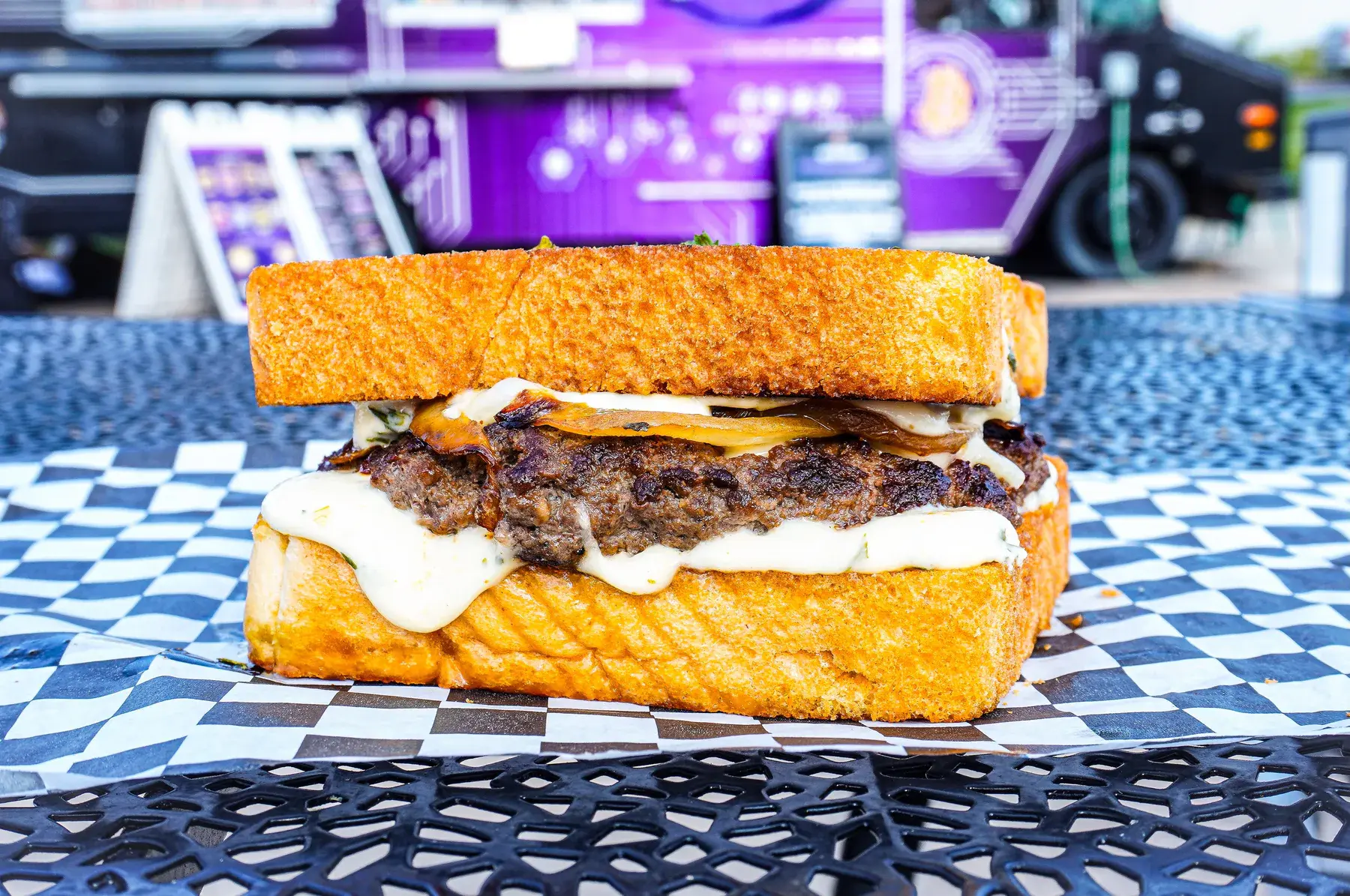 Crypto Melt patty melt on Texas toast with grilled onions and FOMO sauce